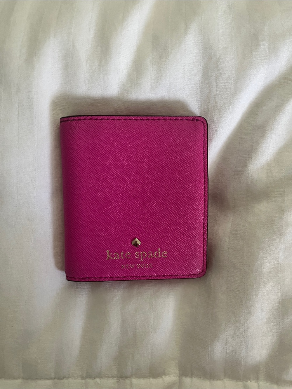 Hot pink Kate Spade Saffiano leather bifold wallet.